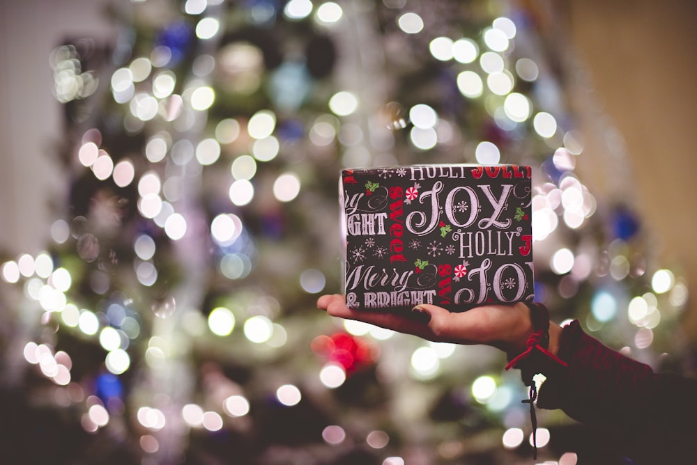 selective focus photography of gift box on person's palm