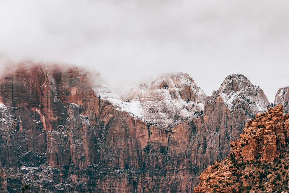 brown mountain covered by snow during daytime