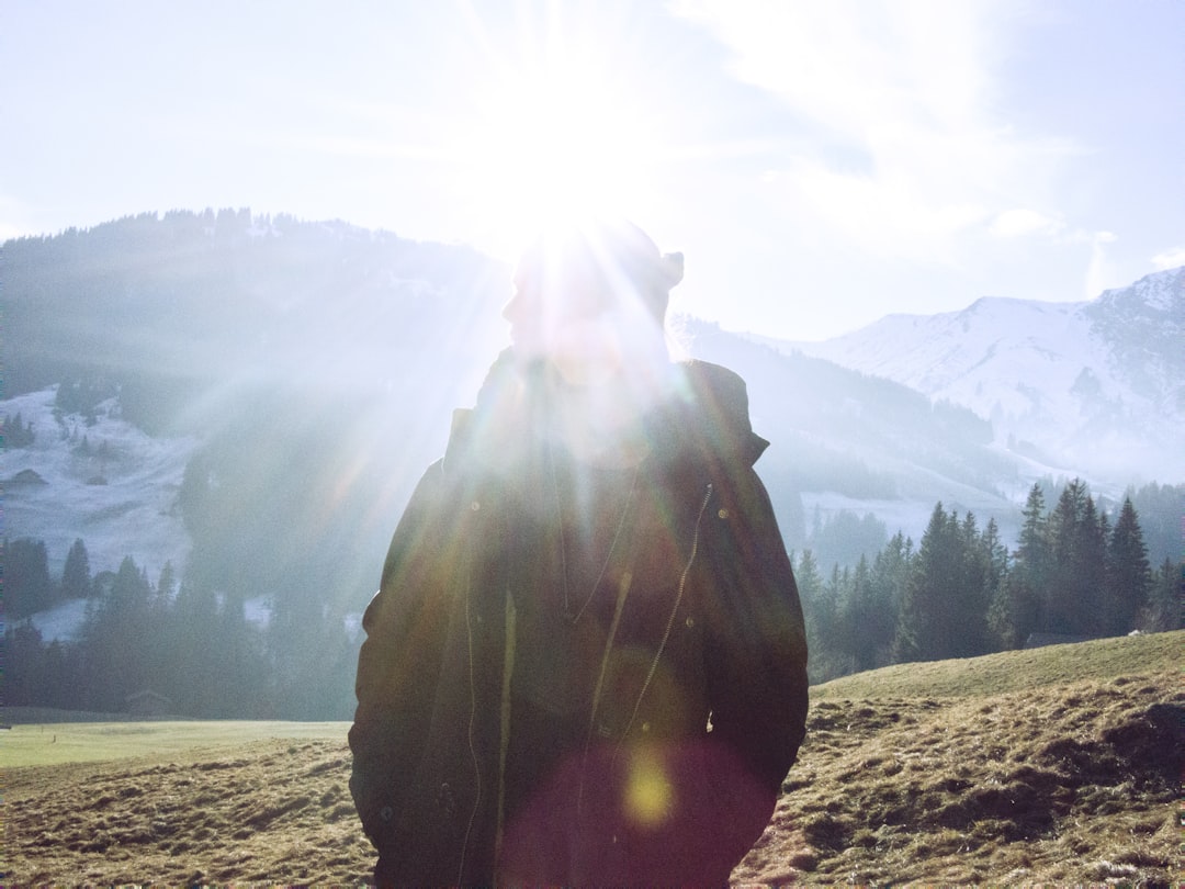 silhouette of person facing mountain range