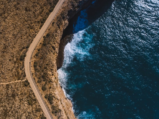 aerial photography of brown cliff beside body of water in Sagres Portugal