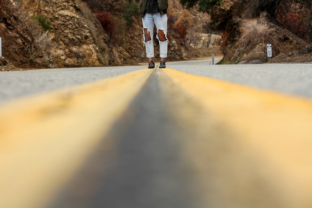 person walking on road