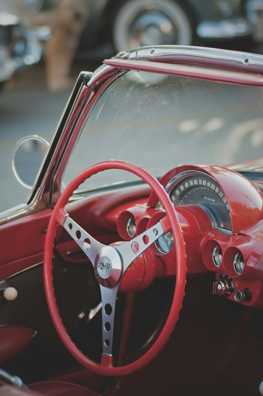 red vehicle steering wheel in closeup photo