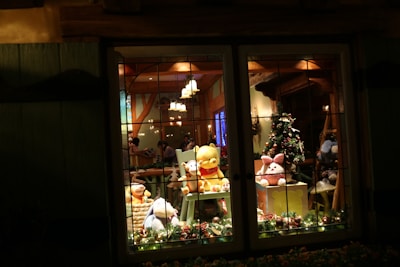 A festive room decorated with twinkling lights where families watch Santa's video together.