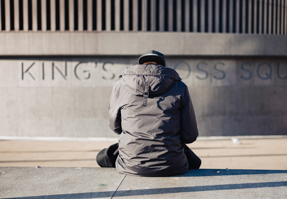 homme en veste grise assis