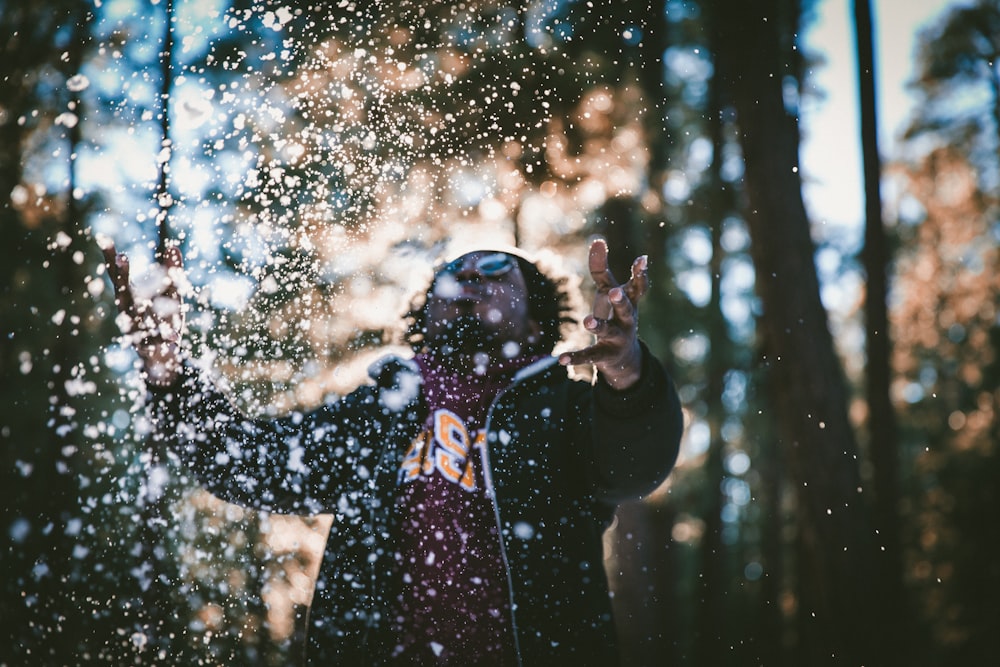 man playing water drops during daytime