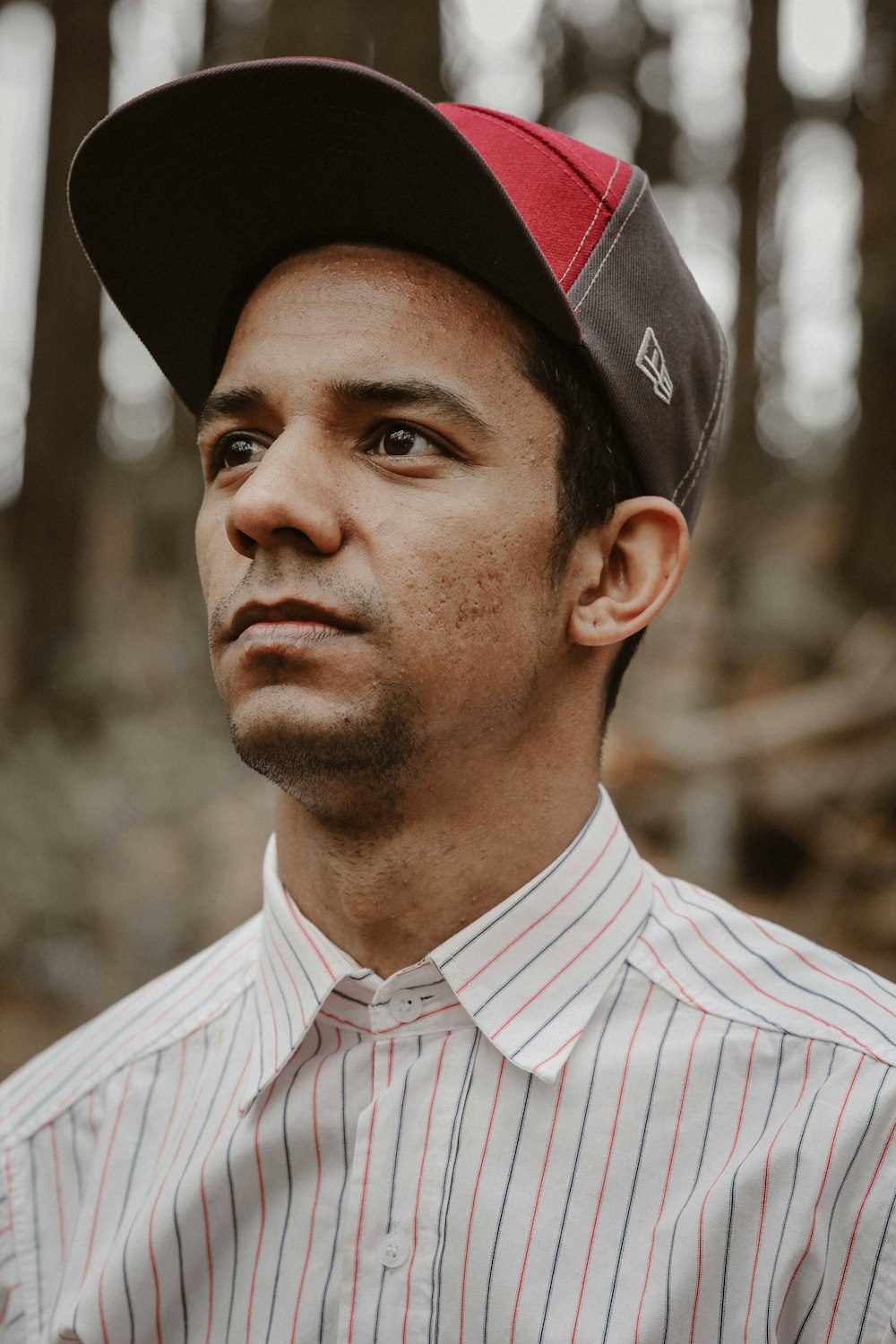 man wearing red, white, and blue pinstriped sport shirt