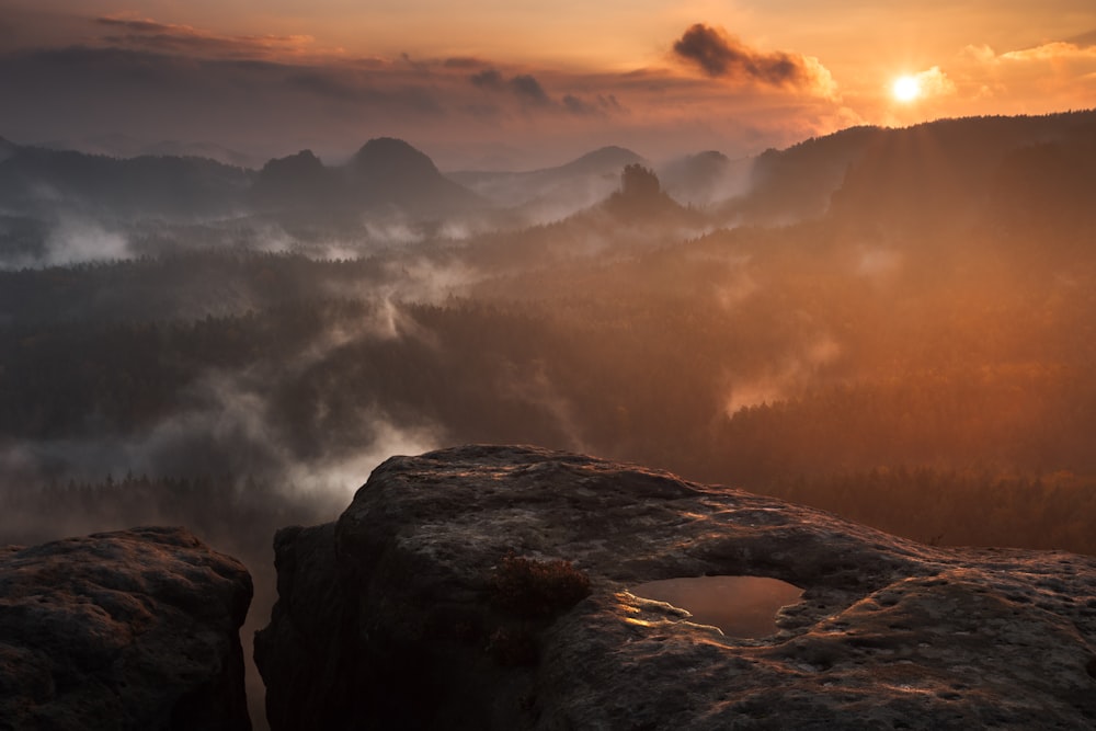 photograph of mountains surrounded by mist