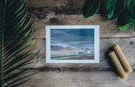High-resolution image of a fine art print laid out on a minimalist wooden table.