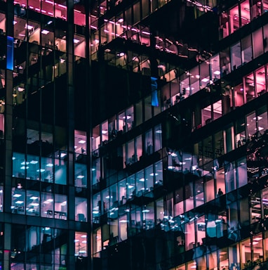 architectural photography of building with people in it during nighttime