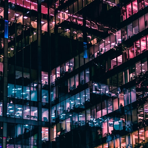 architectural photography of building with people in it during nighttime