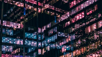 architectural photography of building with people in it during nighttime