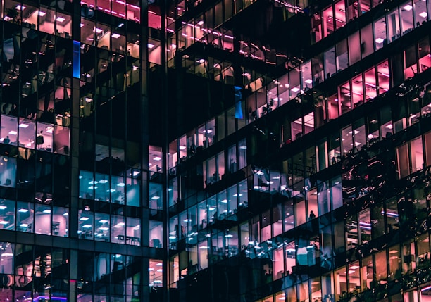 architectural photography of building with people in it during nighttime