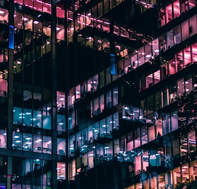 architectural photography of building with people in it during nighttime