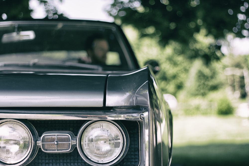 man inside black muscle car