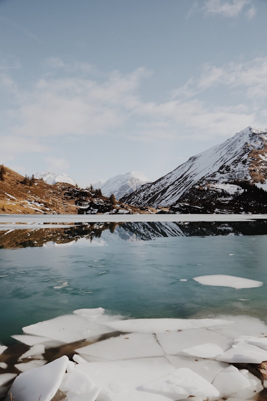 body of water beside mountain covered with snow in Trübsee Switzerland