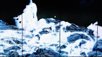 Abstract sound waves flowing over a dark background with glowing light effects.