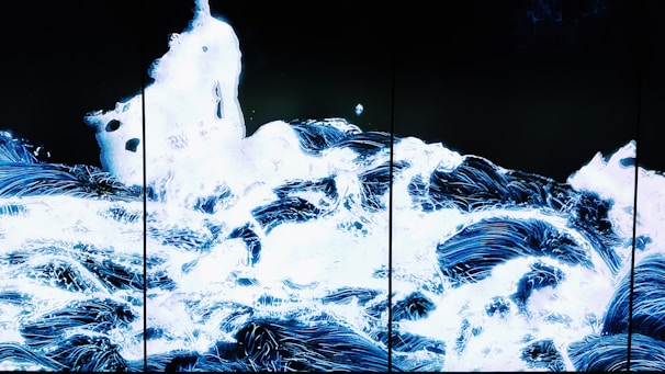 Abstract sound waves flowing over a dark background with glowing light effects.