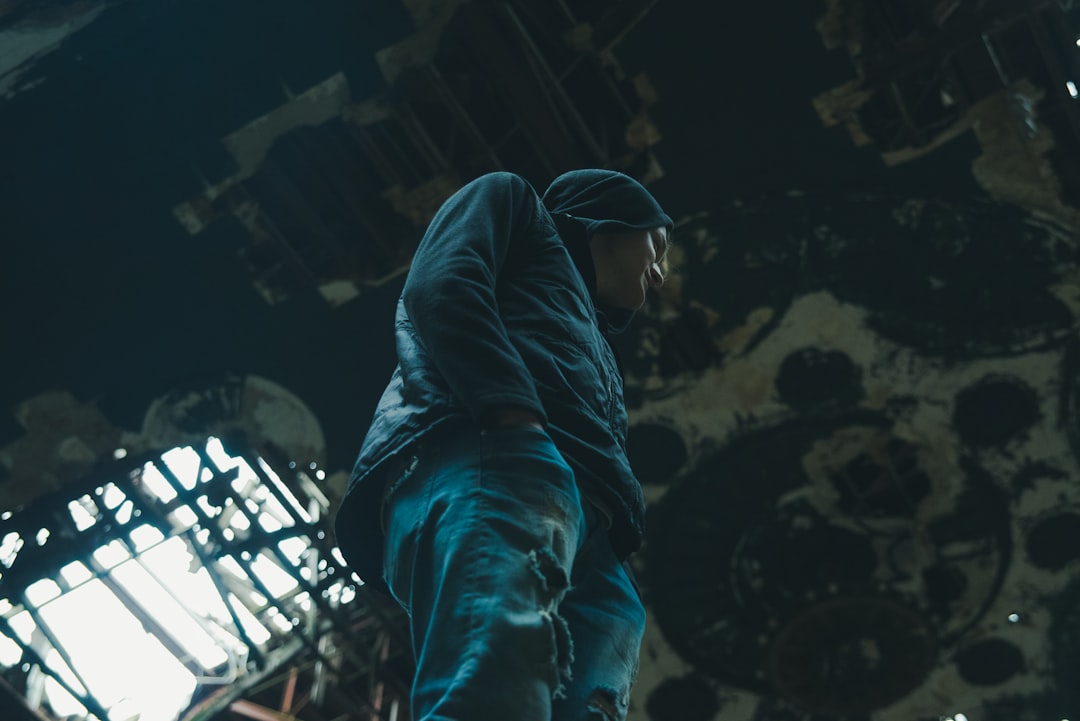 man in hooded jacket standing,