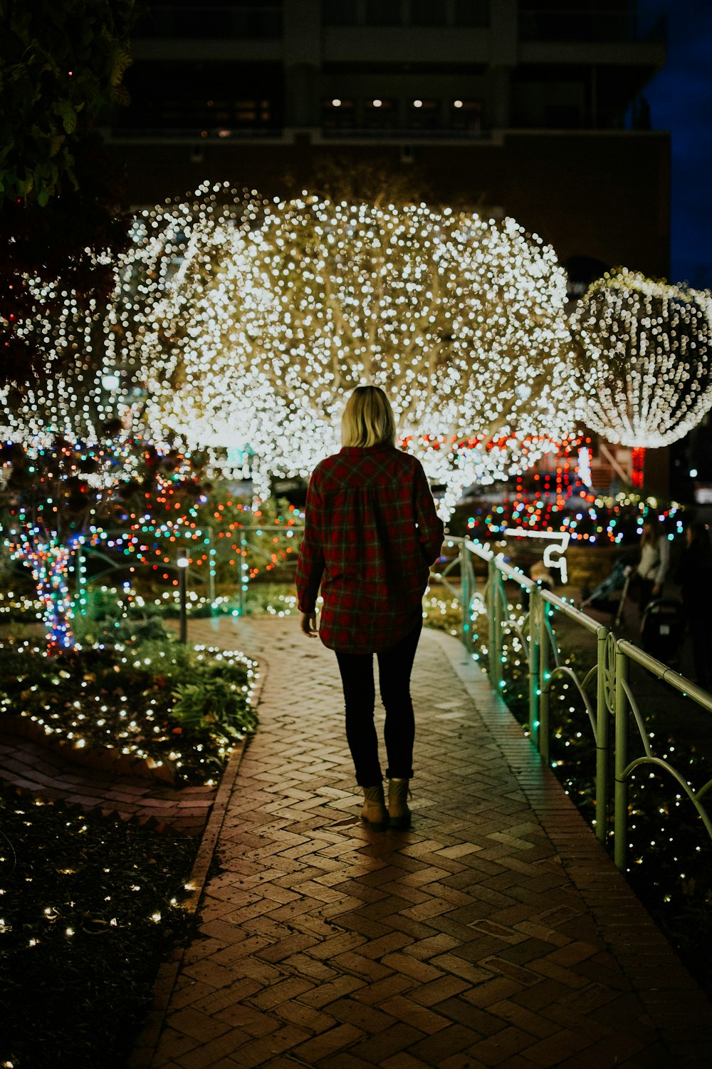 woman wearing brown jacket at night