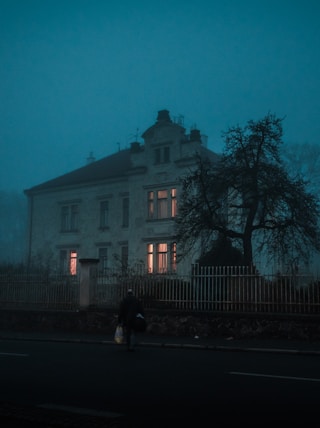 person walking towards house