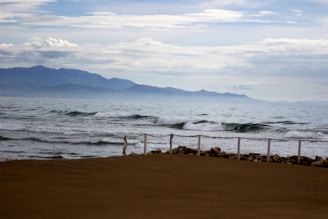 View of nearby beach with gentle waves and sandy shore visible from the property.