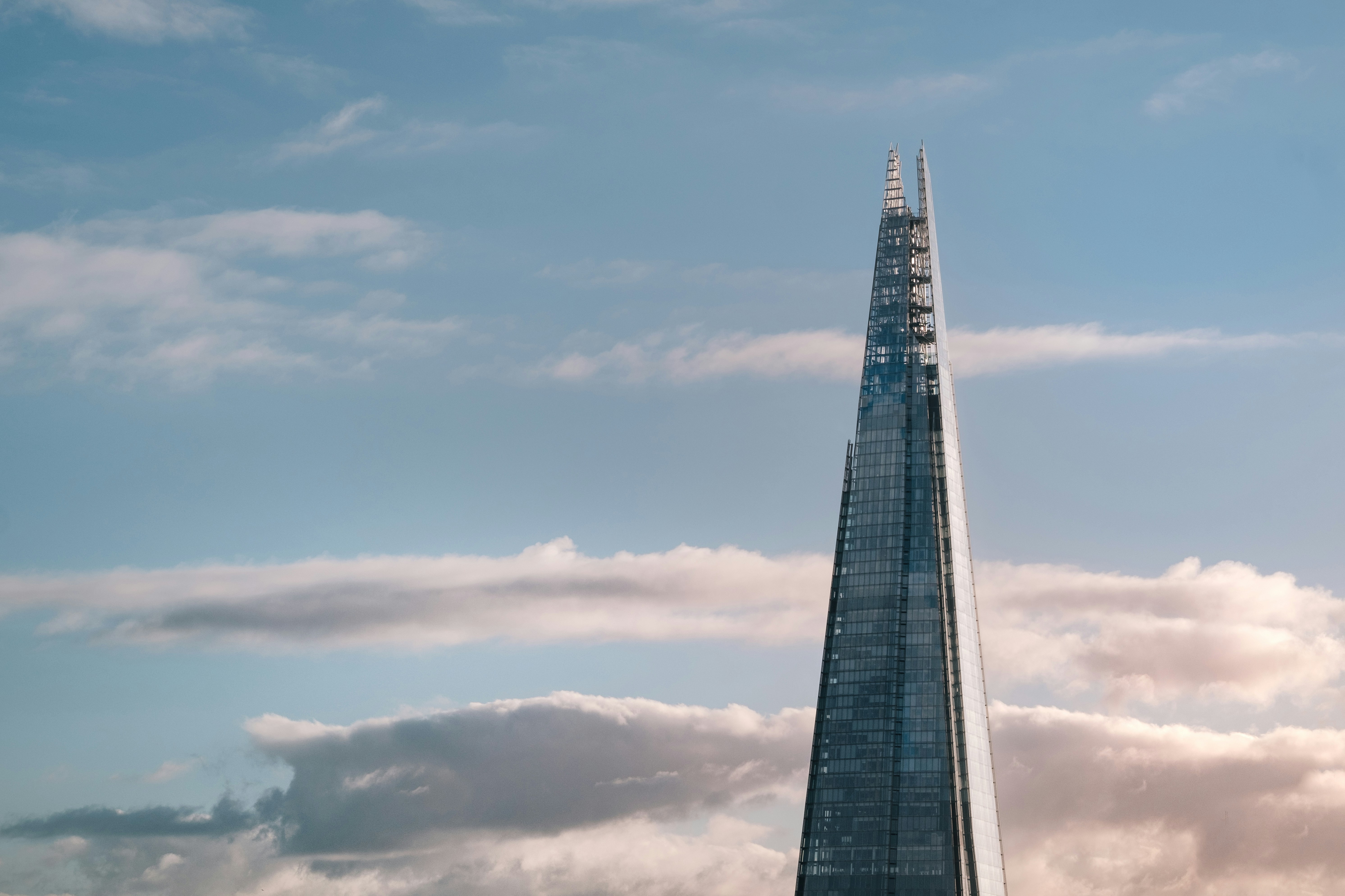 high-rise tower with white clouds in background