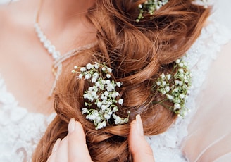 woman holding her hair with flower