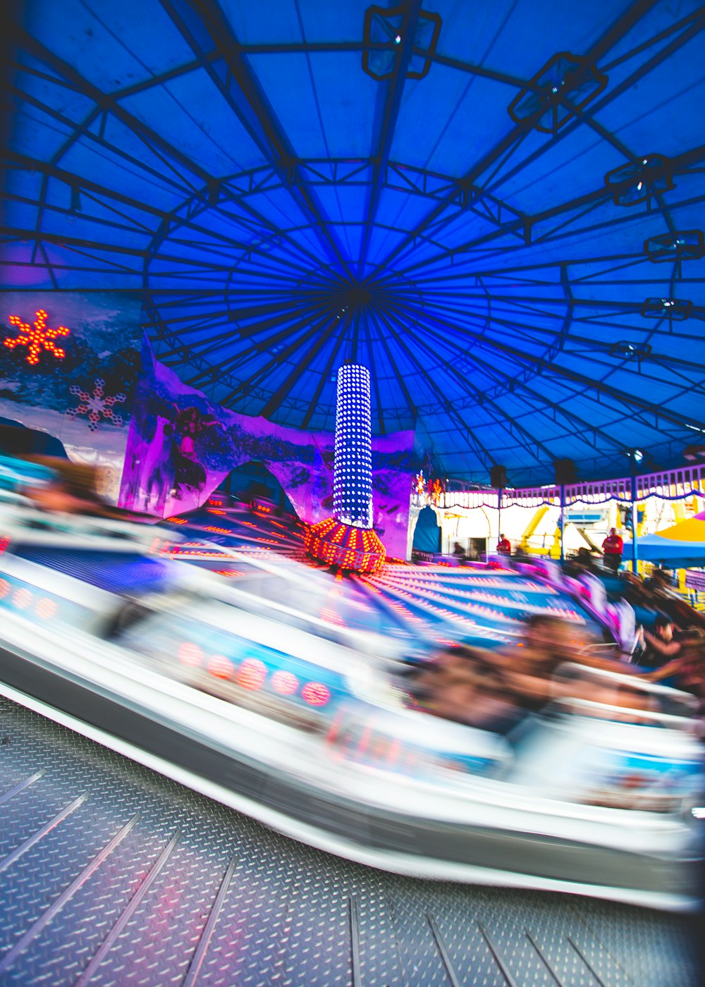 people riding carousel during daytime