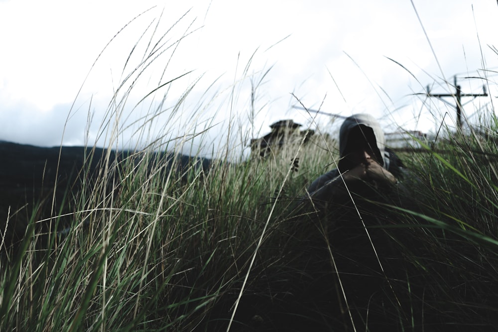 man in hoodie near grass