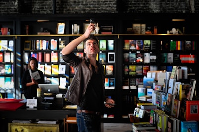 man holding black phone talking photo inside room
