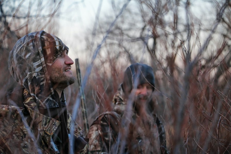 Two men hunting together in the woods