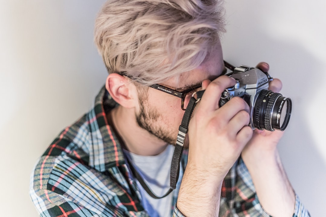 man taking photo using camera