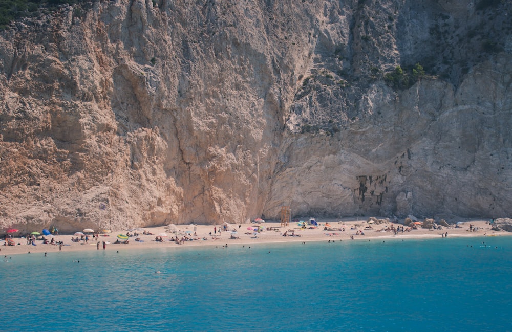 blue body of water near brown rock formation