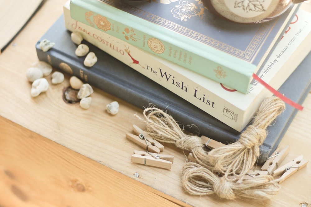 assorted title books near clothes pin and rope