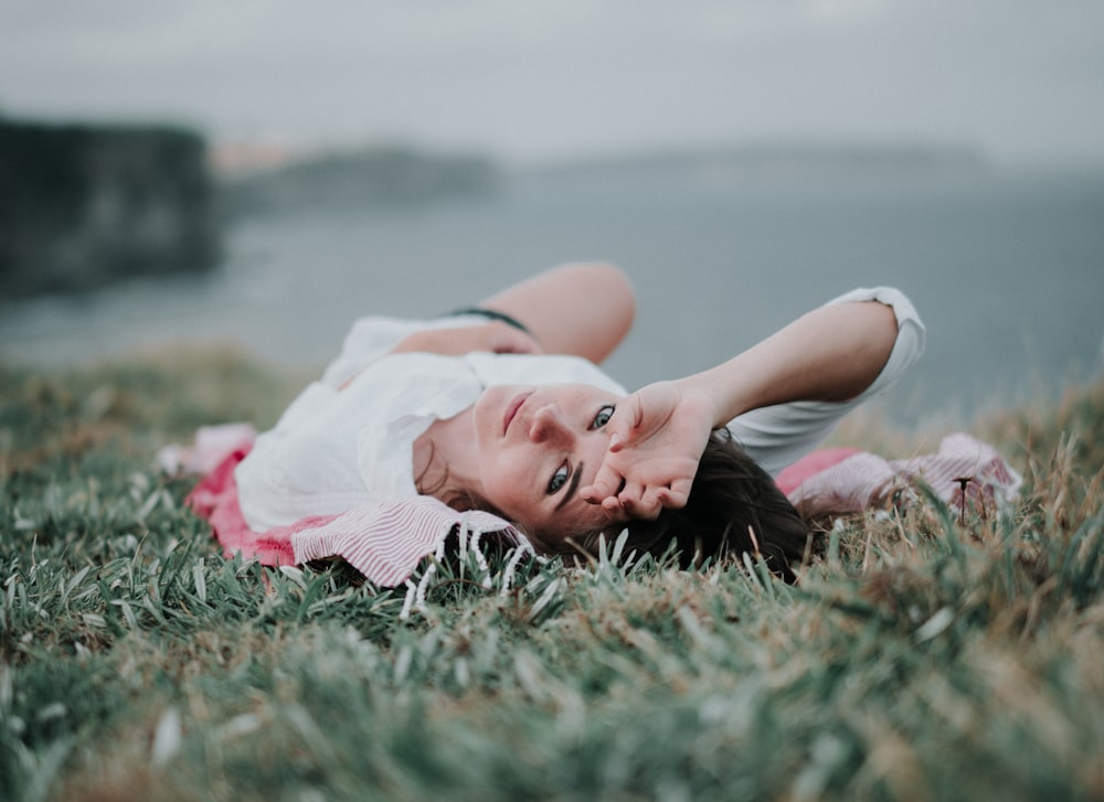 selective focus of woman lying on green grass