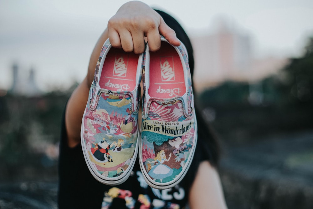 tilt shift lens photography of Vans Alice in Wonderland slip-on shoes