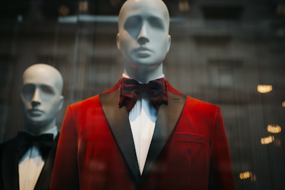 mannequin wearing red notched lapel suit jacket fancy teams background