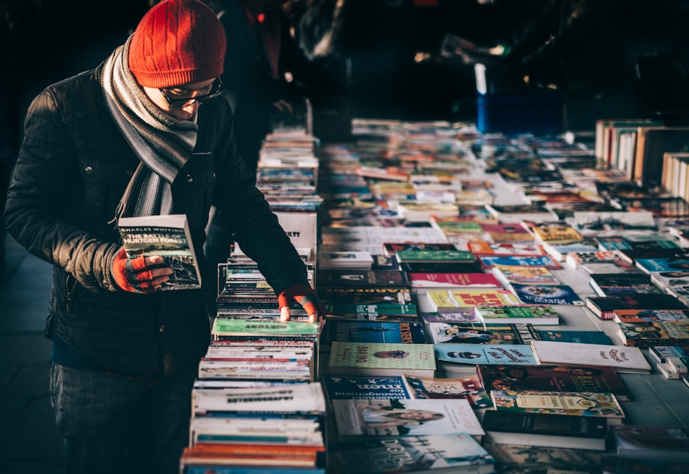 man picking up book ob book sale