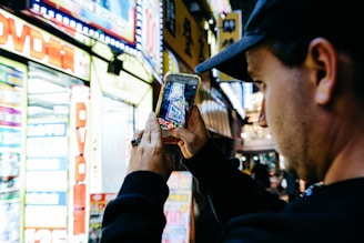 A smiling traveler using a smartphone with a vibrant Tokyo cityscape in the background.