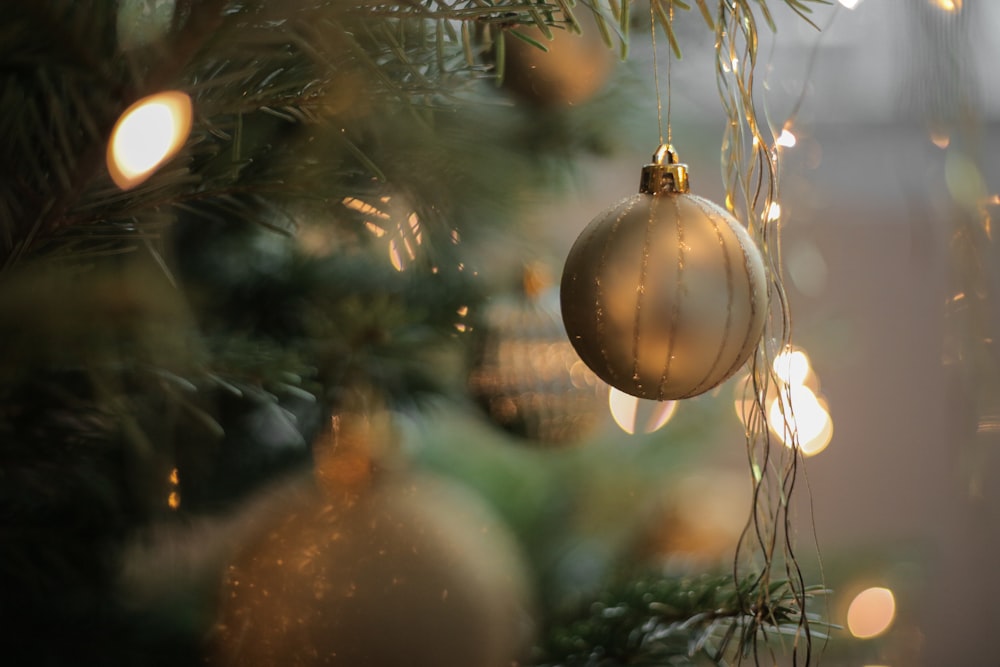 A focused shot on a silver Christmas tree ornament.