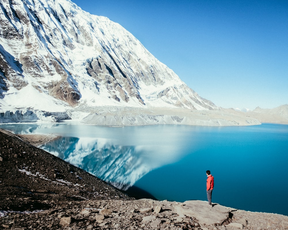 man standing on top of mountain