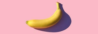 riped banana on pink surface