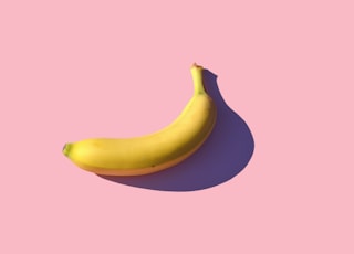 riped banana on pink surface