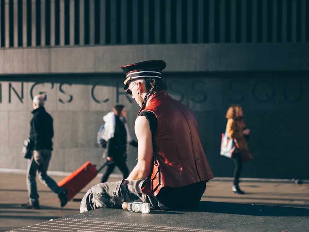 man sitting on pavement