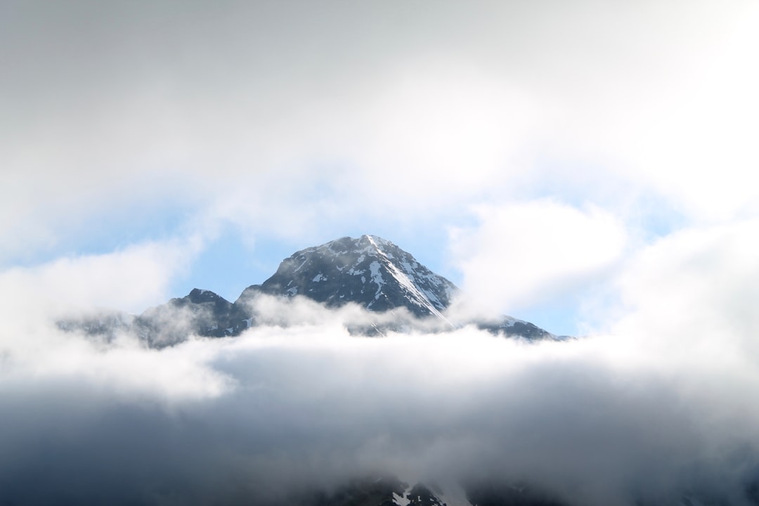 black mountain covered with white clouds