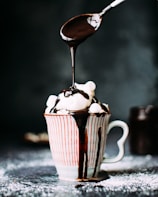 chocolate pouring on vanilla ice cream in ceramic cup