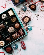 chocolates with box on white surface