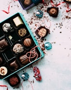 An assortment of handmade artisanal chocolates wrapped in tan and purple ribbons