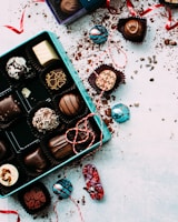 chocolates with box on white surface