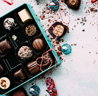 chocolates with box on white surface